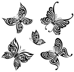 Wall Mural - Vector background with the image set of black and white butterflies in the form of a tribal tattoo 