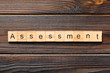 assessment word written on wood block. assessment text on table, concept