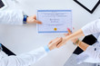 © khmelev - Doctor congratulates intern on receiving diploma and shakes hands in hospital