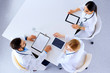 © khmelev - Group of doctors with gadgets in hospital , top view