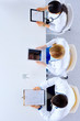 © khmelev - Group of doctors sitting in he office with gadgets and tablets in hospital , top view