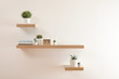 © New Africa - Wooden shelves with beautiful plants and calendar on light wall