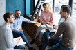 © opolja - Beautiful business people are using gadgets, talking and smiling during the conference in office.