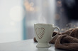 © New Africa - Delicious morning coffee and knitted sweater on white table indoors