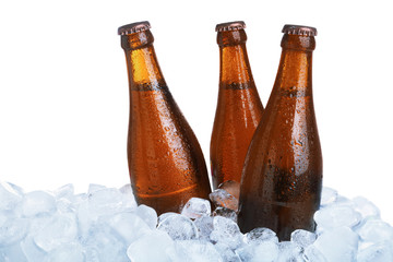 Ice cubes and bottles of beer on white background