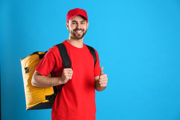 Poster - Courier with thermo bag on light blue background, space for text. Food delivery service