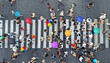 Rainy weather. People crowd with umbrellas moving through the pedestrian crosswalk. Top view from drone.