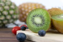 Delicious And Healthy Kiwi And Pineapple Fruit On Wooden Background.