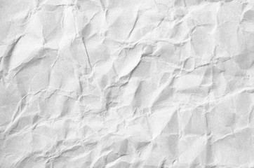 Creative background with scattered overlay of crumpled white paper.