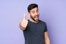 Caucasian Handsome Man With Thumbs Up Because Something Good Has Happened Over Isolated Purple Background