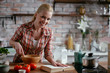 © JustLife - Woman in kitchen. Portrait of beautiful woman cooking.