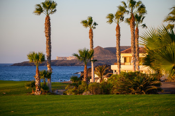 View on evergreen grass field on large golf course and blue Atlantic ocean on Tenerife island, Canary, Spain