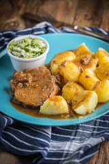 Poster - Braised meat in sauce served with boiled potatoes.