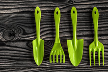 Gardening Tools Concept. Spade, Rake And Fork On Black White Wooden Background With Space For Text Flat Lay Top View.