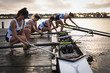 © Wavebreak Media - Female rowing team training on a river