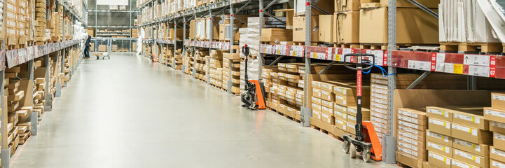 Rows of shelves with boxes in modern warehouse