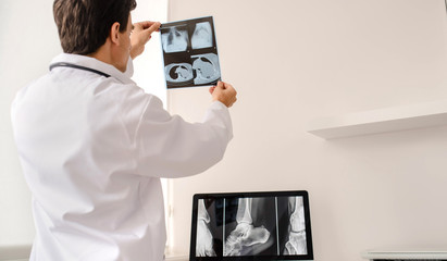 Back view of young man radiologist doctor