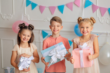 Wall Mural - Happy birthday Happy cute children in festive decor and beautiful dresses with gifts in their hands.