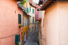 High Angle Aerial View On Chiusi, Italy Street Narrow Alley In Small Historic Town Village In Umbria On Sunny Day With Orange Yellow Bright Vibrant Colorful Walls, Windows Shutters