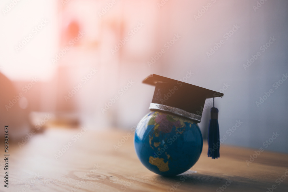 Education study abroad in Global world,Back to School and Graduation cap on student hand holding Earth globe map,Success of Global business study abroad educational,congratulation Graduation Ceremony - obrazy, fototapety, plakaty 