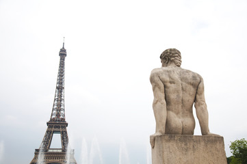  Statue of man with Eiffel tower and the fountain in Paris, France