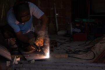 welder with protective mask welding steel