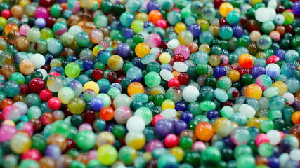 Colourful beads scattered throughout the background texture. Pattern, Decoration, Wallpaper.