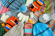 A lot of hats, gloves, mittens. Warm clothes in the form of knitted hats, mittens, gloves, scarves for the cold seasons. Multi-colored clothes for autumn and winter.