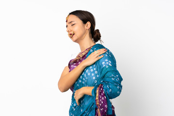 Young indian woman isolated on white background suffering from pain in shoulder for having made an effort