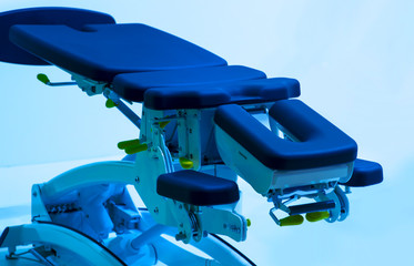 Blue gynecological chair in medical office in clinic. Modern interior in the gynecologist's office, smart medical backgroynd.