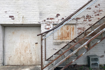 Wall Mural - alley warehouse loading receiving door rusted stairs