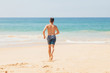 © stone36 - Teenage boy, running into the water, at the ocean sandy beach. Travel and vacation concept.