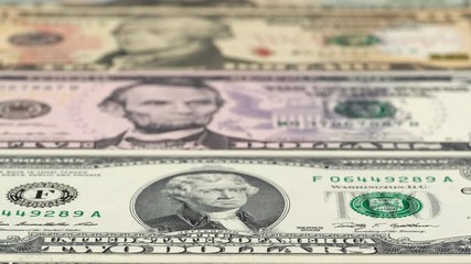 Wall Mural - Full set of US dollar bills close up tracking. US dollars background. Slider shot, low angle. 4K, 422 10 bit