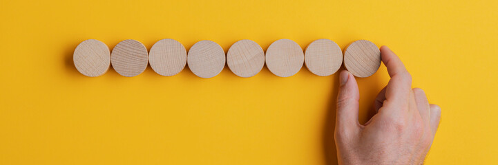 Wall Mural - Placing eight blank wooden cut circles in a row