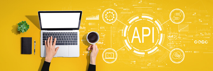 api - application programming interface concept with person using a laptop computer