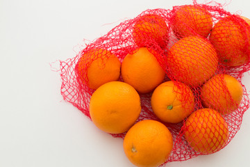 fresh oranges with net on the white background.