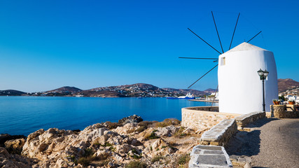 Wall Mural - Old white traditional windmill built into the seashore