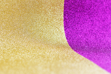 Gold and purple curved gliter paper. space for text..