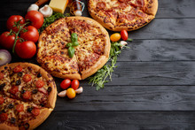 Freshly Served, Three Various Pizzas Placed Among Tasty Ingredients. Top View