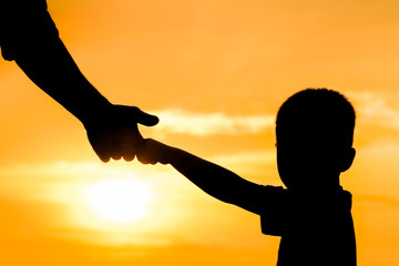 happy dad with a child in the park outdoors silhouette