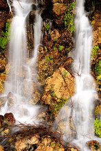 Time Little Waterfall With Orange Rocks And Green Plants