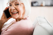 © Yakobchuk Olena - Cheerful old lady in glasses talking on cellphone