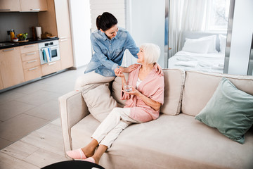 Wall Mural - Old lady taking pills and spending time with granddaughter