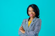 © Carlos David - Portrait of a  happy smiling young woman in business jacket with arms crossed looking to side isolated on blue