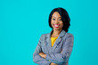 © Carlos David - Portrait of a  happy smiling young woman in business jacket with arms crossed isolated on blue