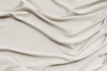 Wall Mural - ecru, cream beautiful satin draped with soft folds, silk cloth background, close-up, copy space