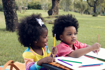 Little african boy and girl playing in backyard