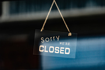 Wall Mural - sorry we are closed sign hanging outside a restaurant, store, office or other