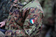 © MoiraM - Details with the uniform and the flag on it of an Italian soldier taking part at the Romanian National Day military parade.