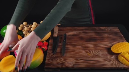 Wall Mural - Video of woman cuts passion fruit on wooden board